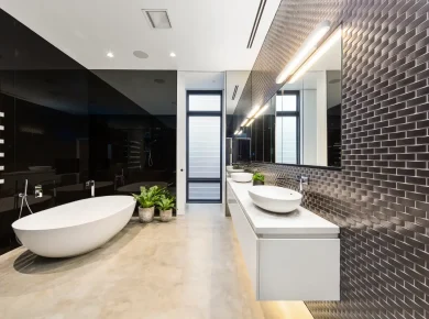 The image showcases a modern bathroom interior. The room features a combination of smooth concrete floors and a brick tile wall pattern.